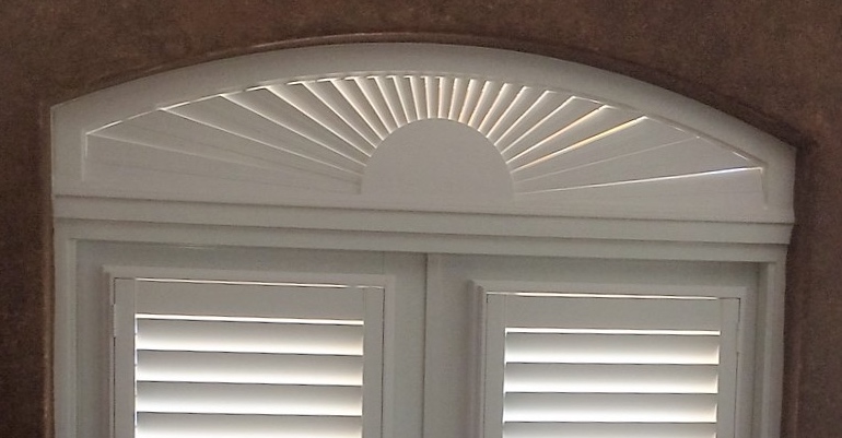 Eyebrow window above door with shutters